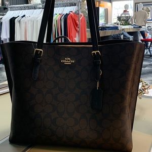 Coach bag with red inner zipper compartment